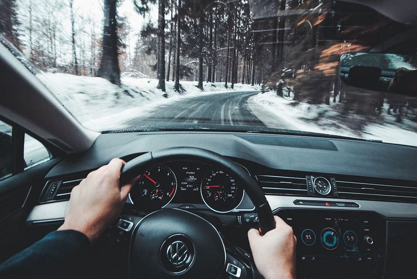 A man driving a car with a view of the road
