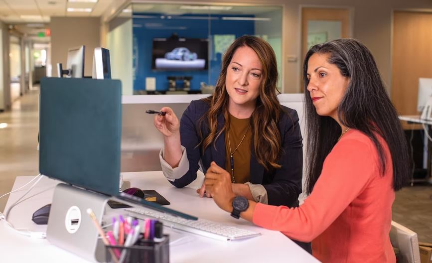 Two women discussing at work