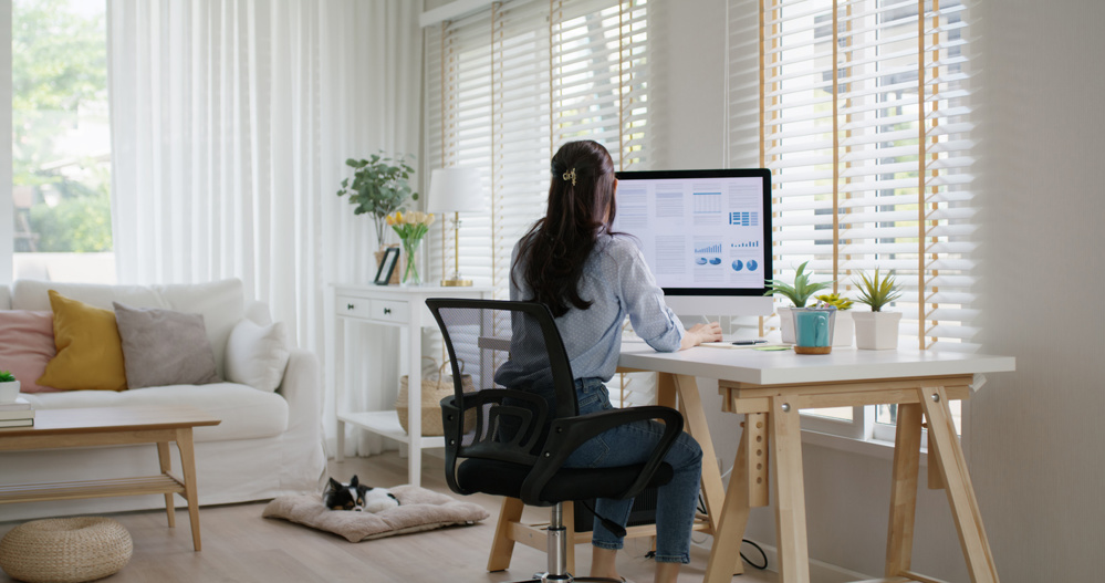 Smart Gen Z tech talent workforce typing SEO sale report on desktop PC happy work easy relax at home office. Remote WFH reskill upskill job MBA study of young people asia woman examine big data graph