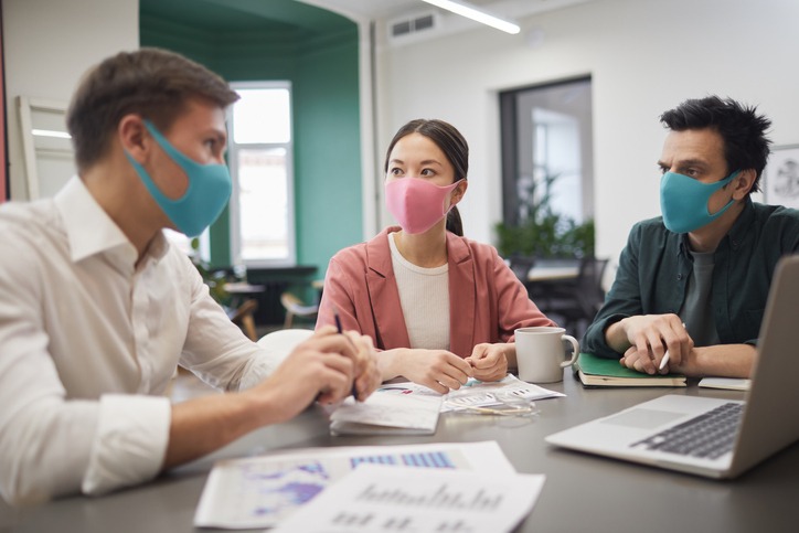 Three people engaged in a business meeting