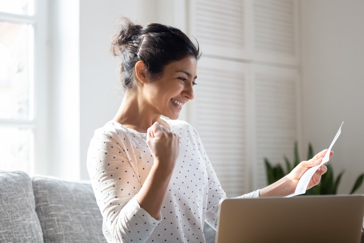 Happy Indian woman reading good news in letter