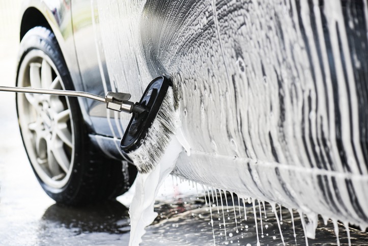 Car wash or cleaning with hight pressured water and using foam.
