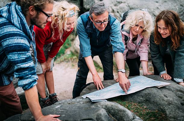 group-of-hikers-checking-route-on-map