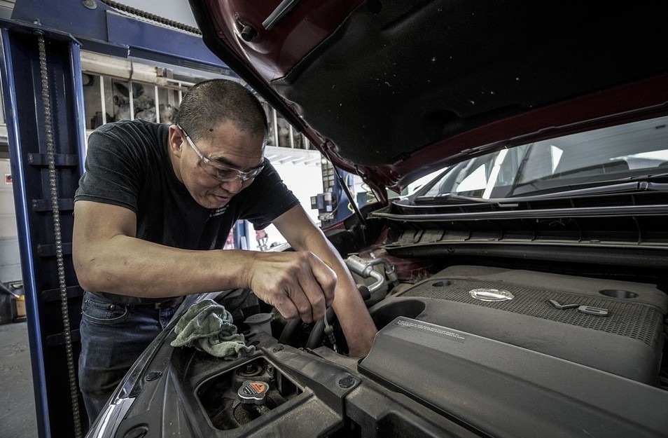 man, a man repairing a car, open car hood, rag