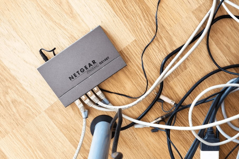 a gray NETGEAR router with cables plugged in