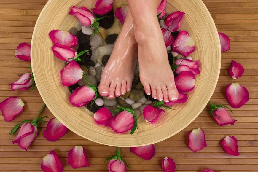 feet in a basin of rose petals
