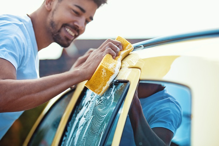 Young Man Washing Car