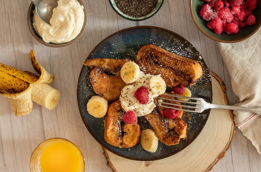 French Toast with banana, French Toast with cream, French Toast with strawberries, elegant presentation of French Toast