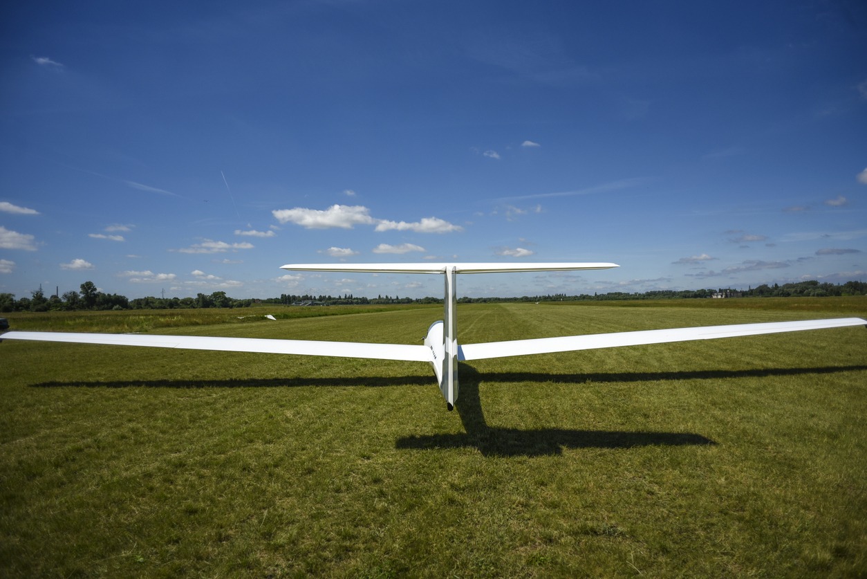 A glider sailplane on grass