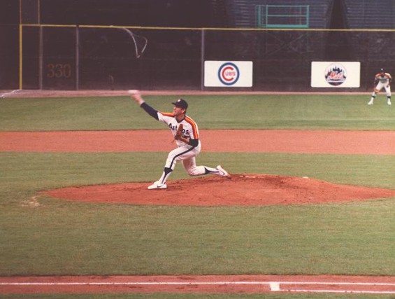 Houston Astro baseball team, one player pitching, green baseball ground