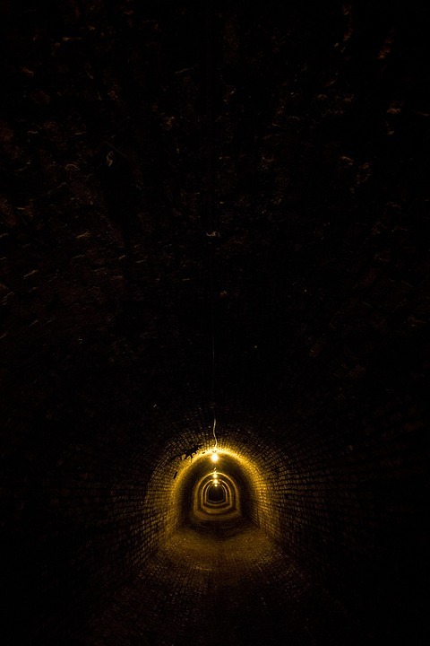 a dark, brick tunnel