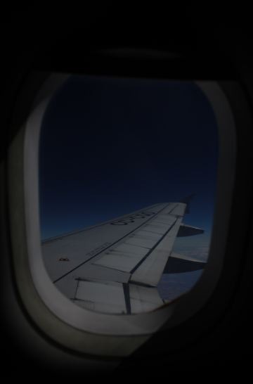 plane window, airplane wing, nighttime photo