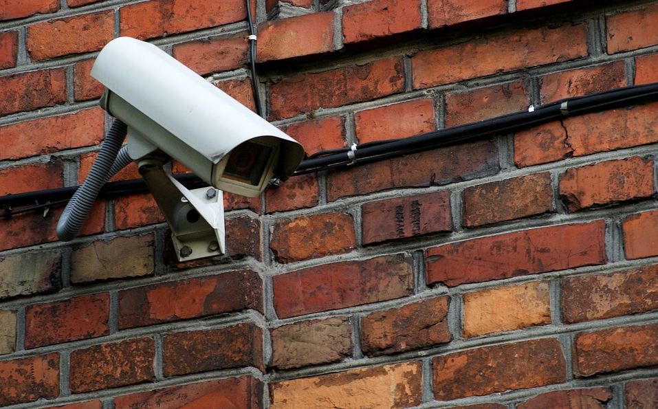 security camera mounted on a brick wall