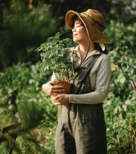 woman with a hat gardening