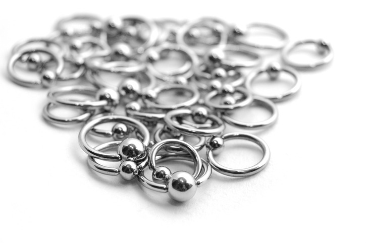 Close-up of scattered stainless circulars with beads