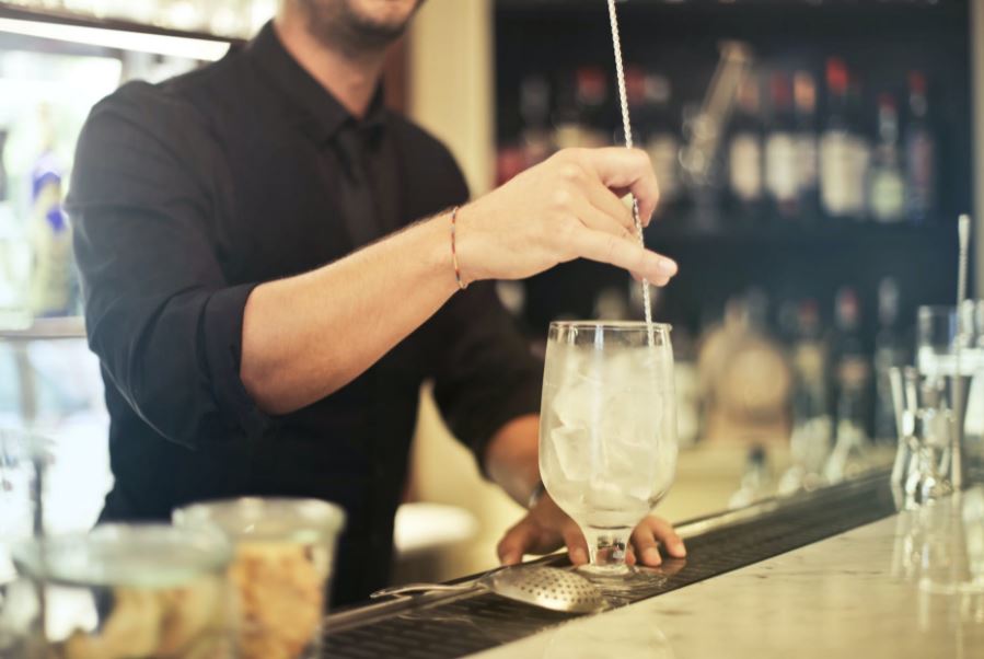 A server putting a straw in a drink